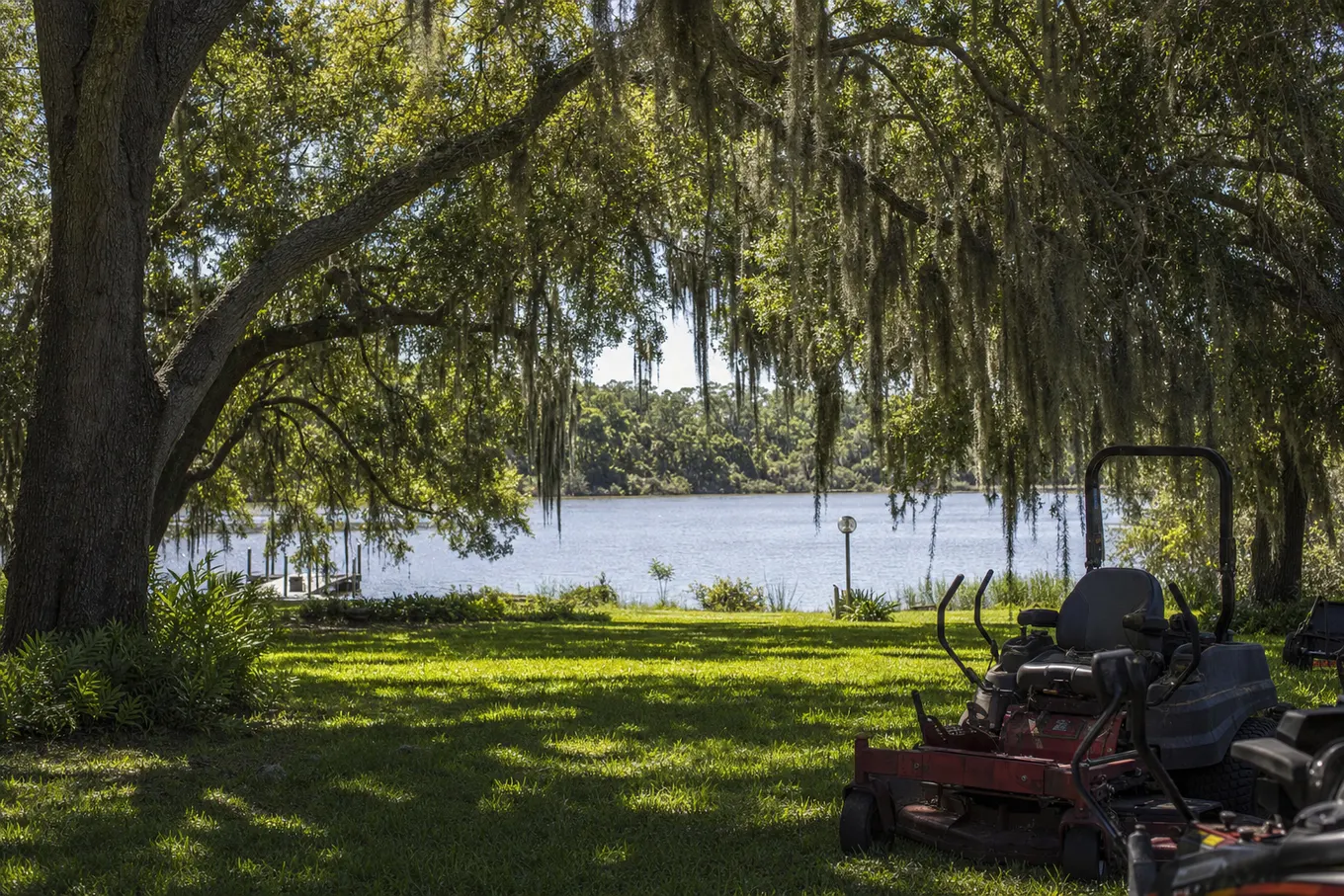 Riverfront lawn under big live oaks with the Peace River beyond