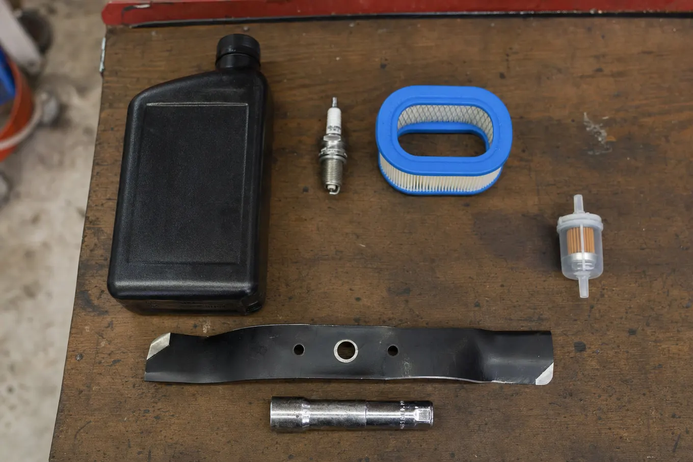 Fresh oil, new spark plug and air filter laid out for a lawn mower tune up in Port Charlotte